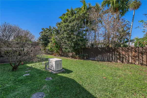 a backyard of a house with a table and chairs