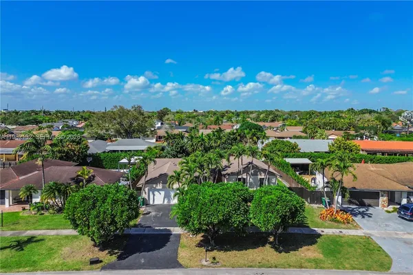 an aerial view of residential houses with outdoor space and street view