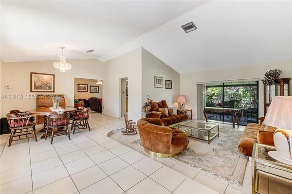 a living room with furniture and a dining table