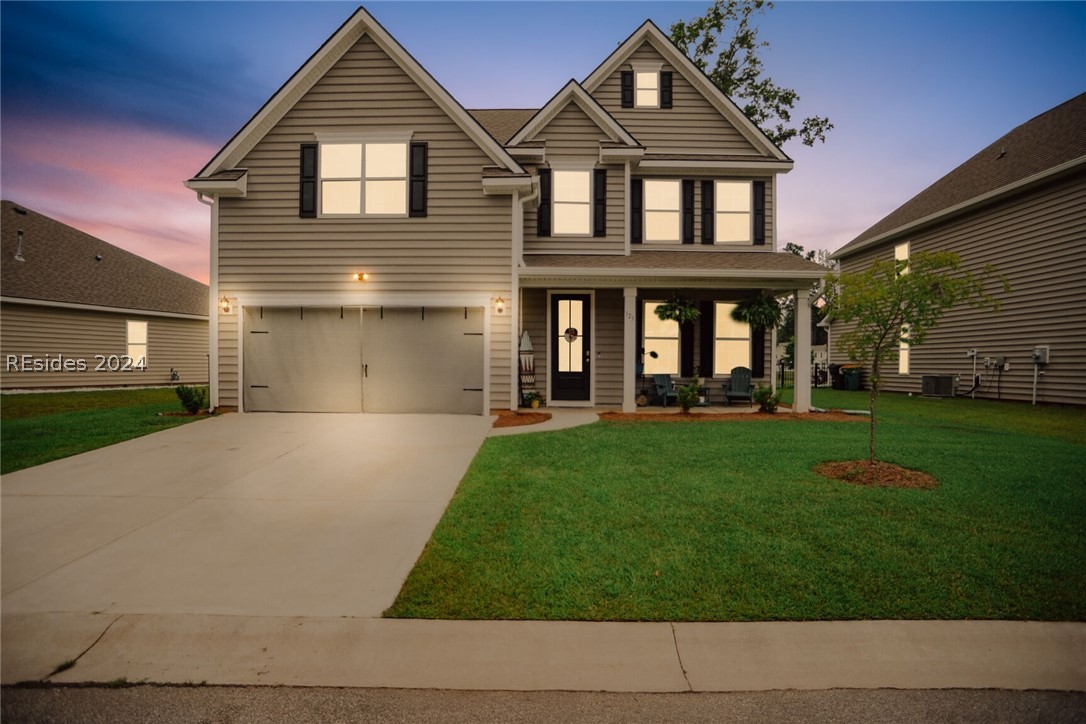 123 Runner Stone Road Bluffton, SC 29909 - Photo 1 of 1 View of front of property with a garage and a yard