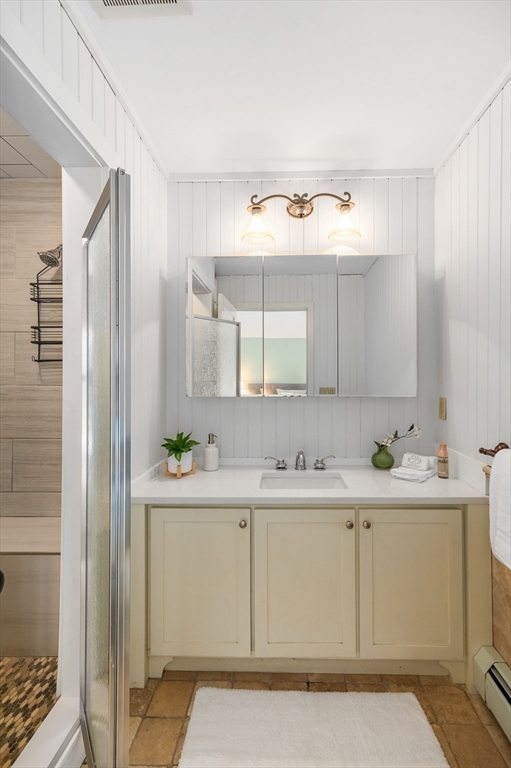 32 Witham Street, Unit B Gloucester, MA 01930 - Photo 17 of 36 a bathroom with a sink a vanity and a mirror