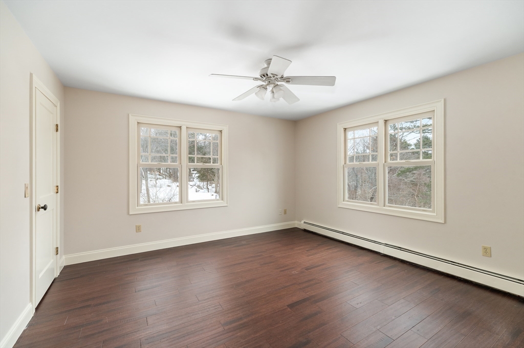 32 Witham Street, Unit B Gloucester, MA 01930 - Photo 21 of 36 a view of an empty room with wooden floor and a window