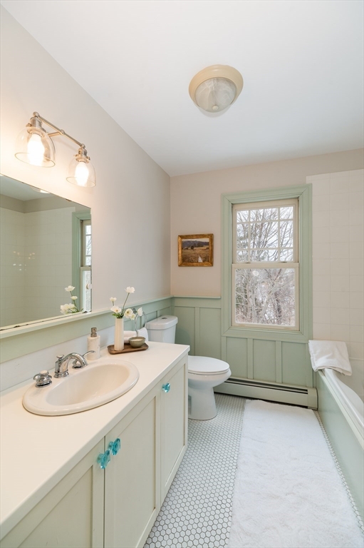 32 Witham Street, Unit B Gloucester, MA 01930 - Photo 23 of 36 a bathroom with a sink a toilet and mirror