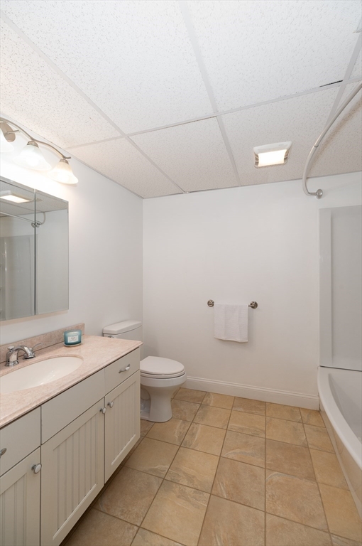 32 Witham Street, Unit B Gloucester, MA 01930 - Photo 28 of 36 a bathroom with a sink a toilet and a mirror