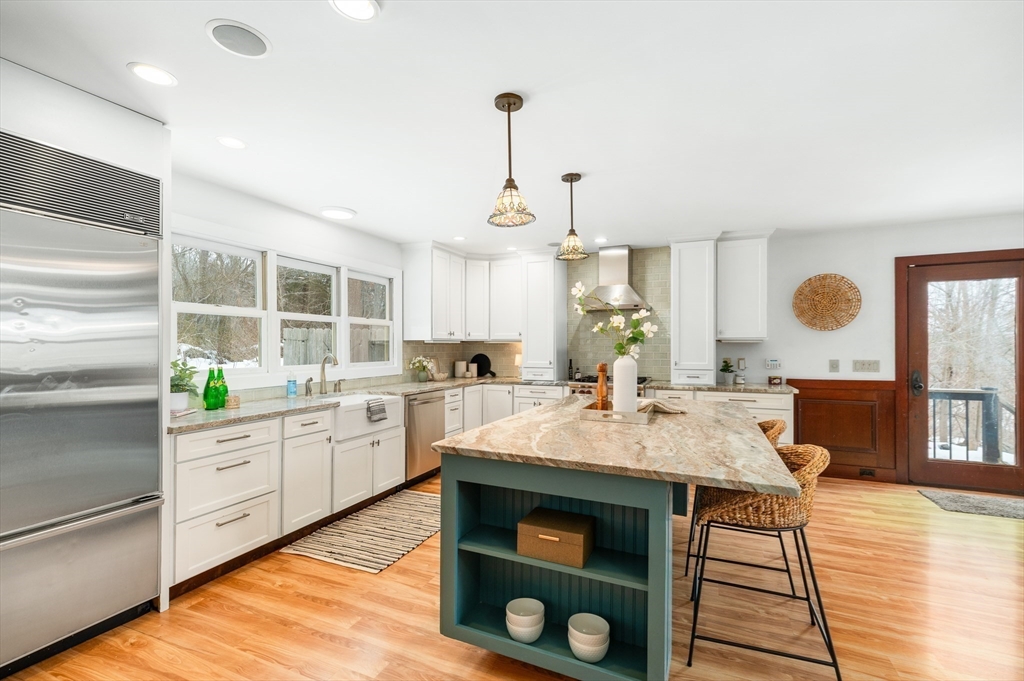 32 Witham Street, Unit B Gloucester, MA 01930 - Photo 5 of 36 a open kitchen with white cabinets appliances and wooden floor