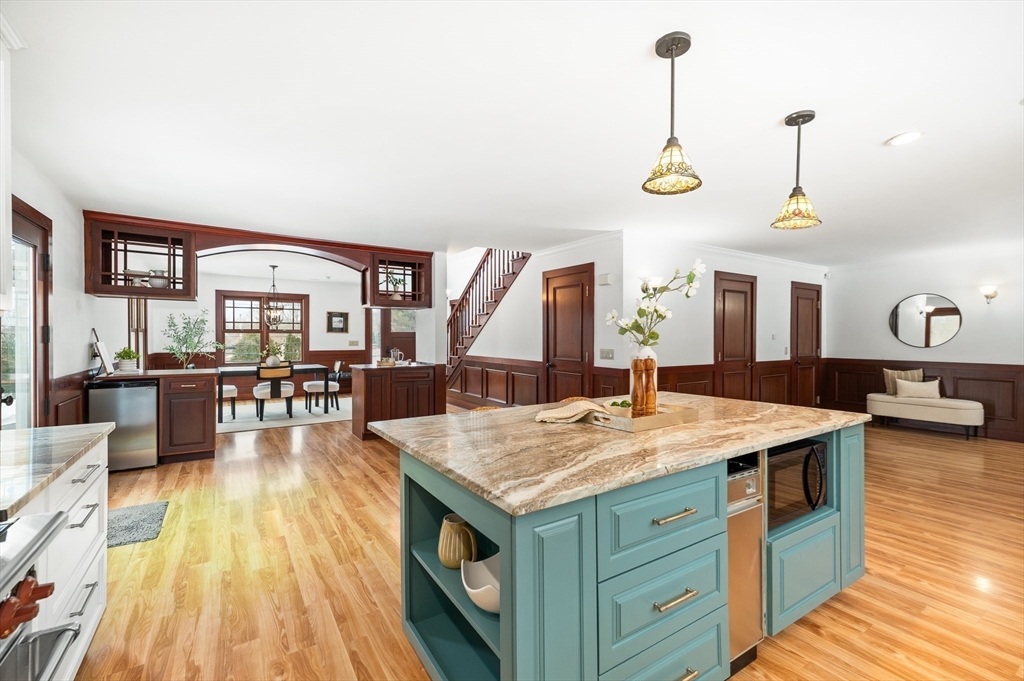 32 Witham Street, Unit B Gloucester, MA 01930 - Photo 7 of 36 a view of a kitchen counter top space with furniture wooden floor and windows