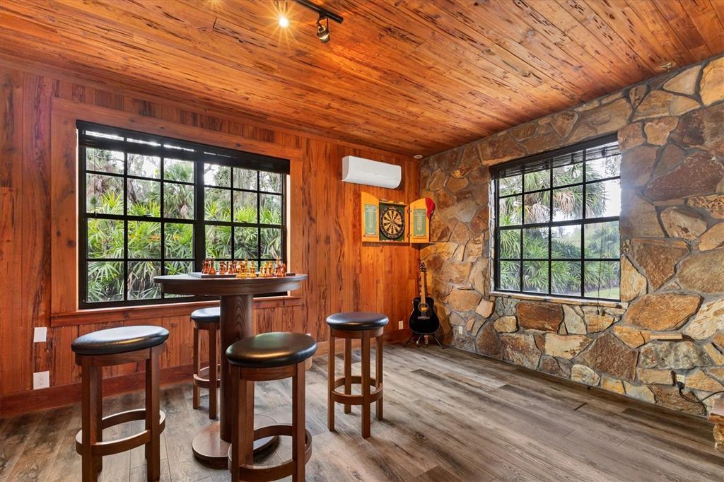 2308 Shadow Oaks Road Sarasota, FL 34240 - Photo 11 of 84 a dining room with furniture a chandelier and wooden floor