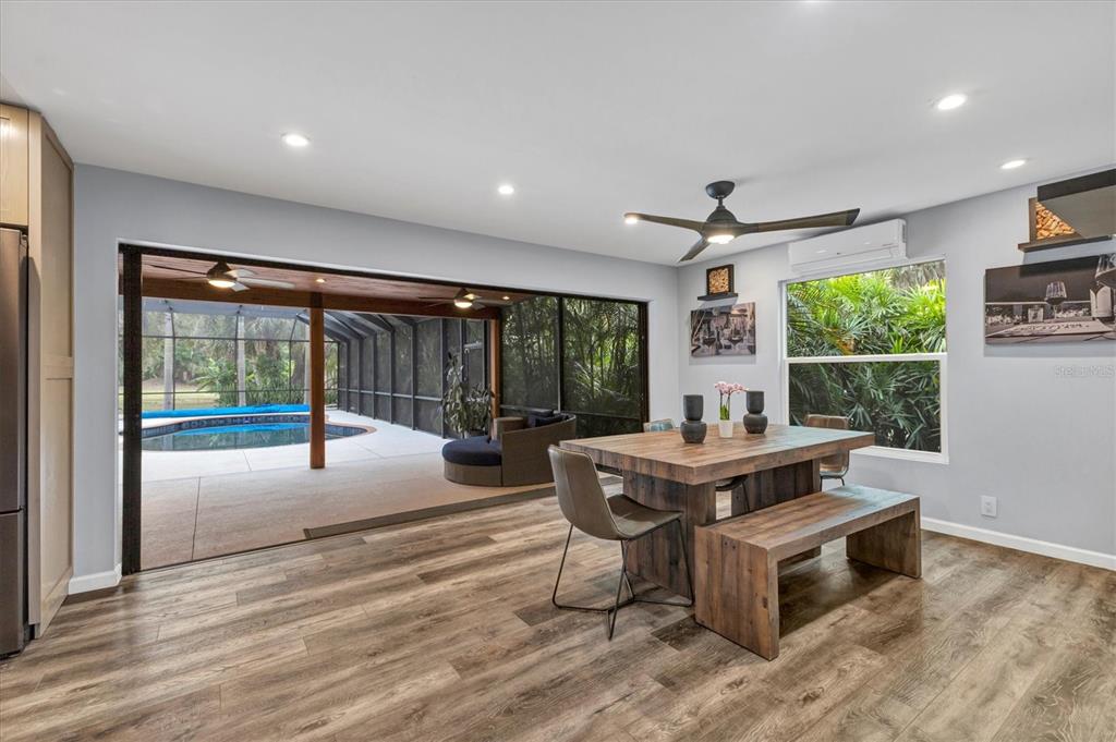2308 Shadow Oaks Road Sarasota, FL 34240 - Photo 14 of 84 a living room with furniture a bed and a large window