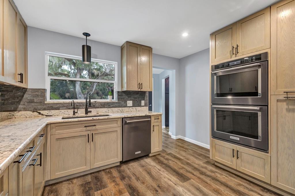 2308 Shadow Oaks Road Sarasota, FL 34240 - Photo 19 of 84 a kitchen with stainless steel appliances a sink cabinets and microwave