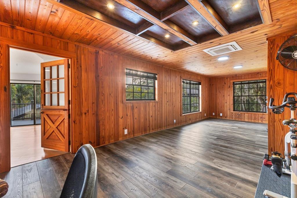 2308 Shadow Oaks Road Sarasota, FL 34240 - Photo 21 of 84 a view of an empty room with wooden floor and a window