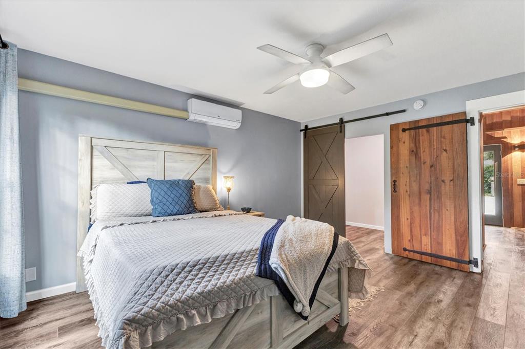 2308 Shadow Oaks Road Sarasota, FL 34240 - Photo 27 of 84 a bedroom with a bed and a chandelier