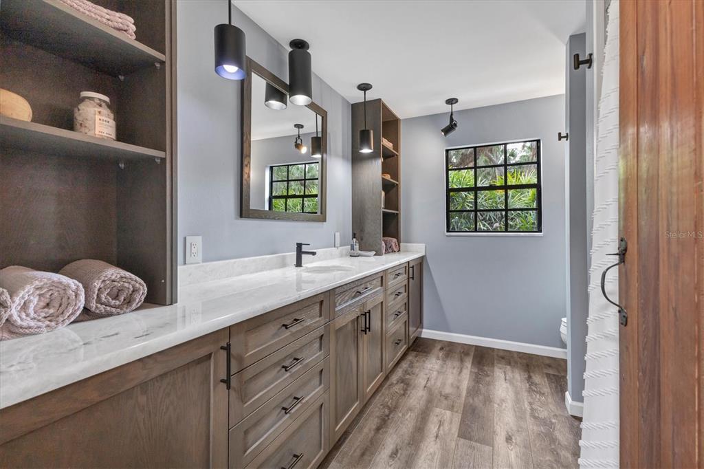 2308 Shadow Oaks Road Sarasota, FL 34240 - Photo 28 of 84 a spacious bathroom with a double vanity sink a mirror and a bathtub