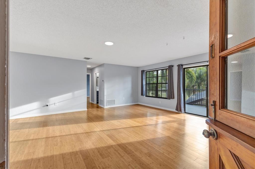 2308 Shadow Oaks Road Sarasota, FL 34240 - Photo 39 of 84 a view of an empty room with wooden floor and a window