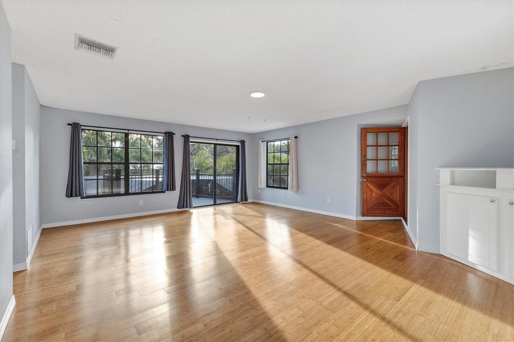 2308 Shadow Oaks Road Sarasota, FL 34240 - Photo 40 of 84 a view of an empty room with wooden floor and a window