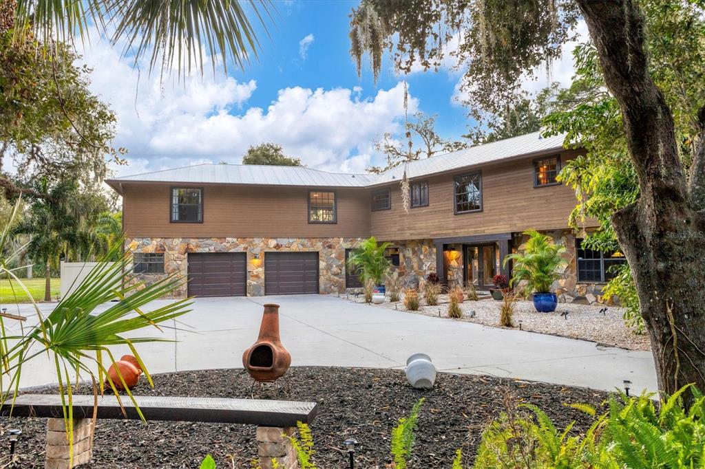 2308 Shadow Oaks Road Sarasota, FL 34240 - Photo 4 of 84 a front view of a house with garden