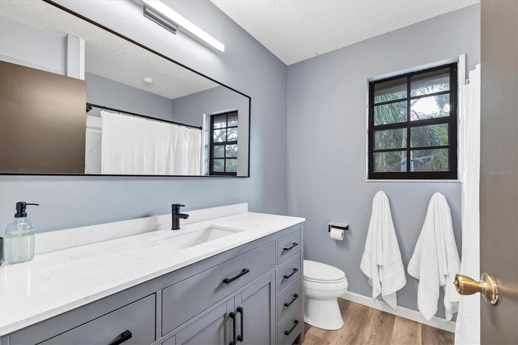 2308 Shadow Oaks Road Sarasota, FL 34240 - Photo 44 of 84 a bathroom with a toilet sink and mirror