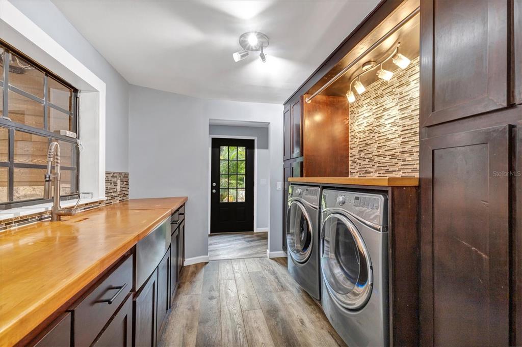 2308 Shadow Oaks Road Sarasota, FL 34240 - Photo 50 of 84 a view of a kitchen with a sink washer and dryer