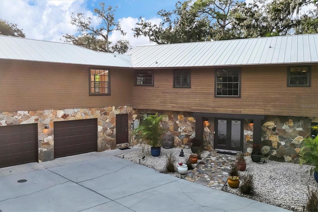 2308 Shadow Oaks Road Sarasota, FL 34240 - Photo 5 of 84 a front view of a house with a yard and garage