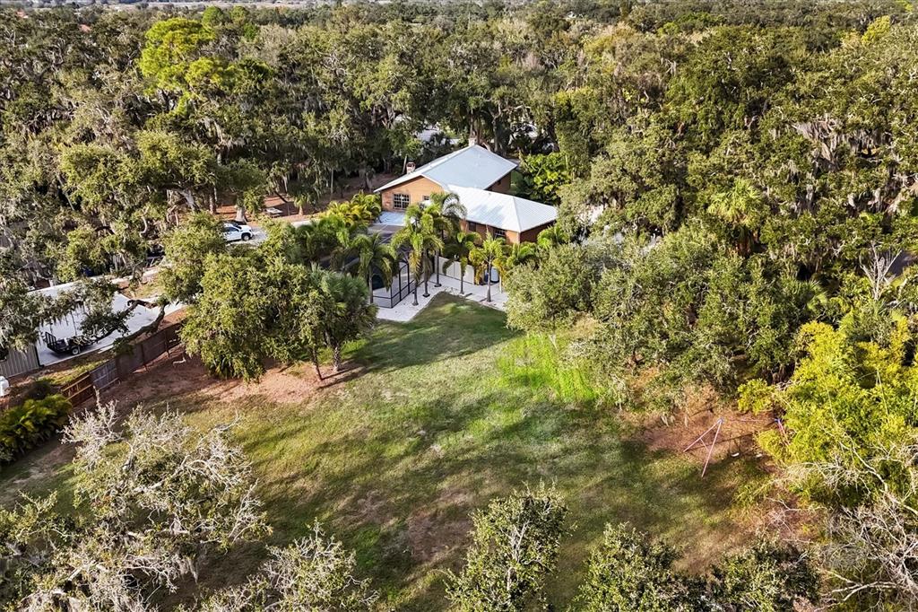 2308 Shadow Oaks Road Sarasota, FL 34240 - Photo 63 of 84 a backyard of a house with a yard and fountain