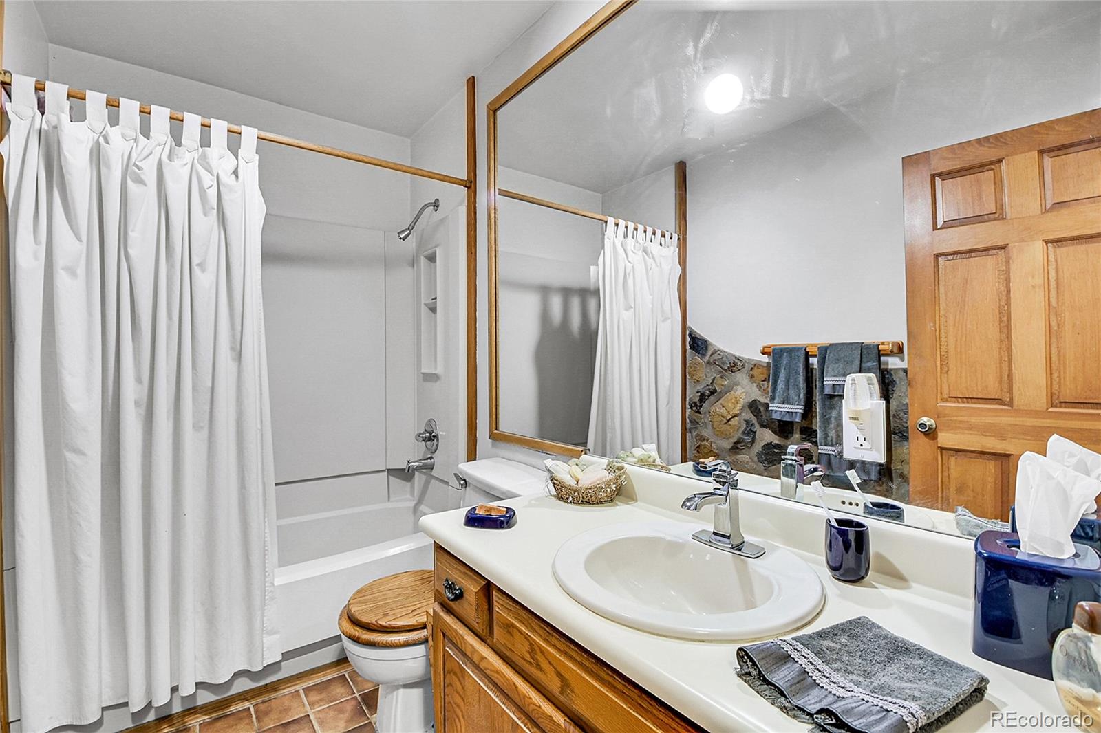 13082 South Wamblee Valley Road Conifer, CO 80433 - Photo 17 of 35 a bathroom with a sink toilet and shower