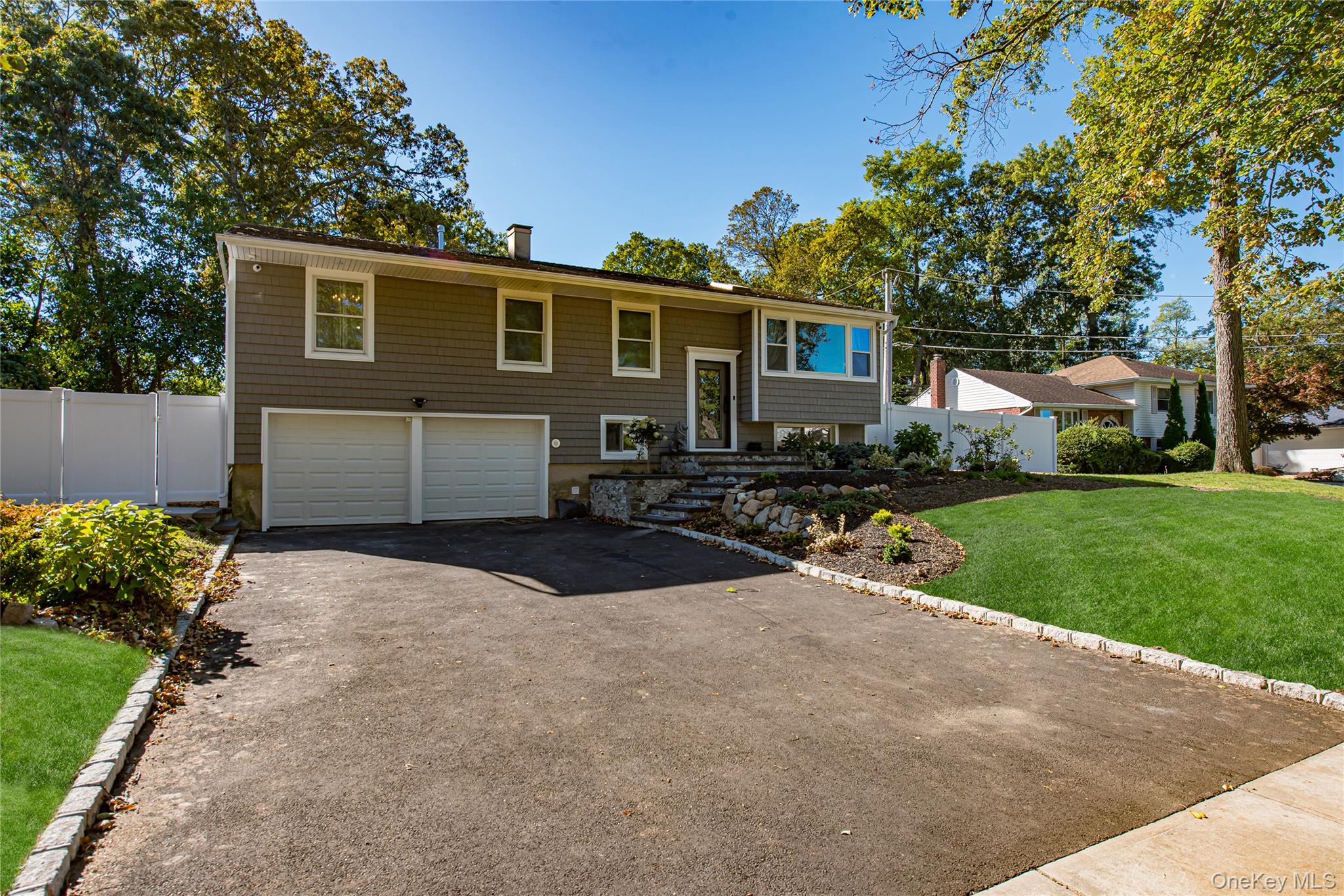 10 Dewey Road Commack, NY 11725 - Photo 1 of 1 Bi-level home featuring asphalt driveway and an attached garage