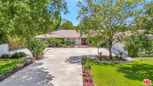 a view of a garden with plants and a lake view