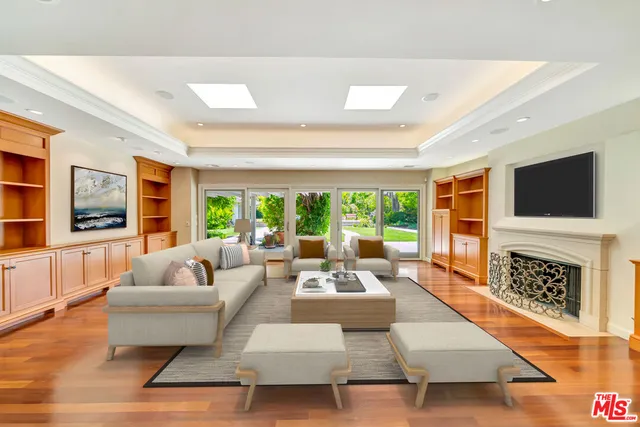 a kitchen with stainless steel appliances granite countertop a stove and a view of living room