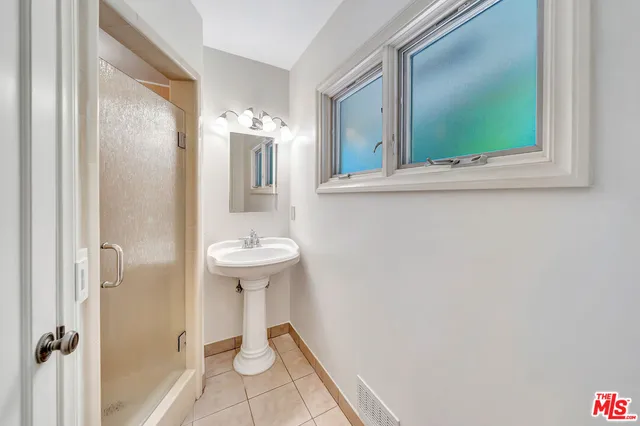 a view of empty room with wooden floor and fireplace