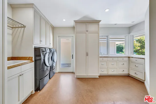 a view of walk in closet with wooden floor