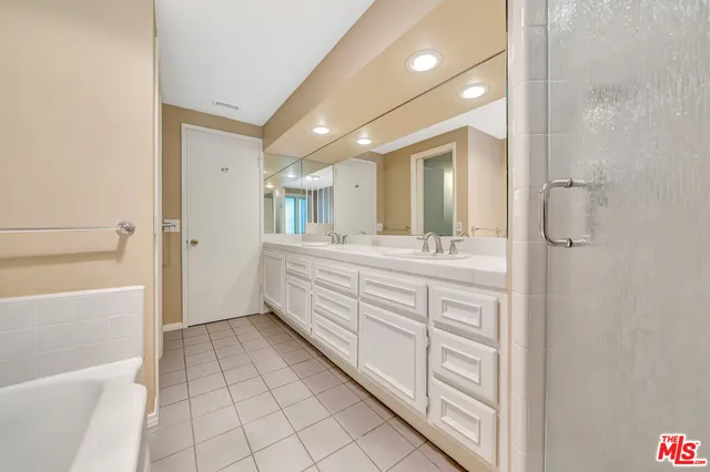 a spacious bathroom with a granite countertop sink mirror and toilet