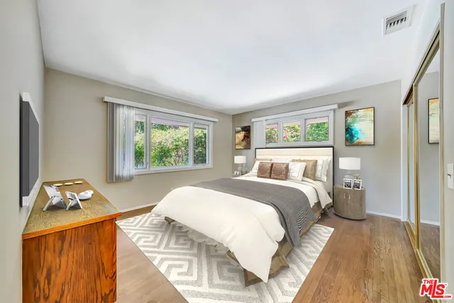 a view of a house with a yard and potted plants