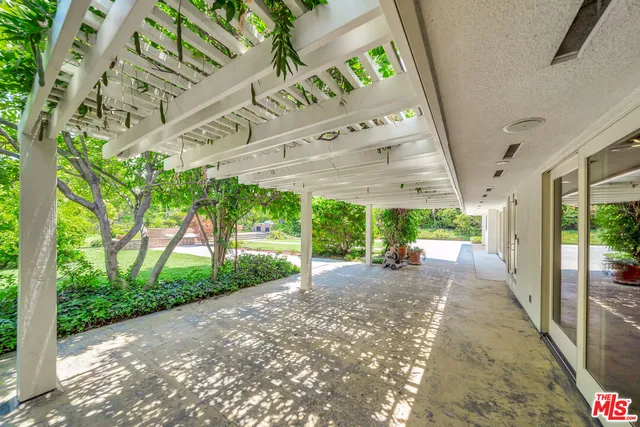an aerial view of residential house with an outdoor space and seating