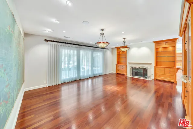 a view of a kitchen with wooden floor and a fireplace