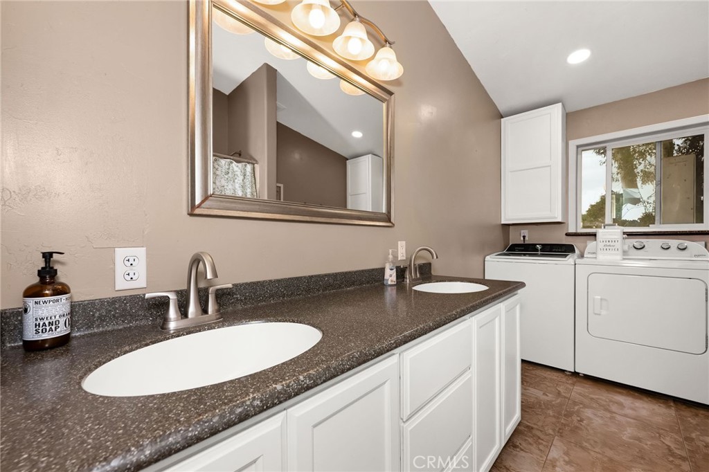 2728 Pentz Road Oroville, CA 95965 - Photo 23 of 52 a bathroom with a granite countertop double vanity and a mirror