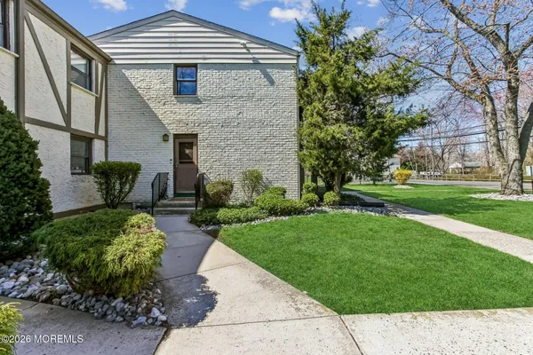a backyard of a house with garden and plants