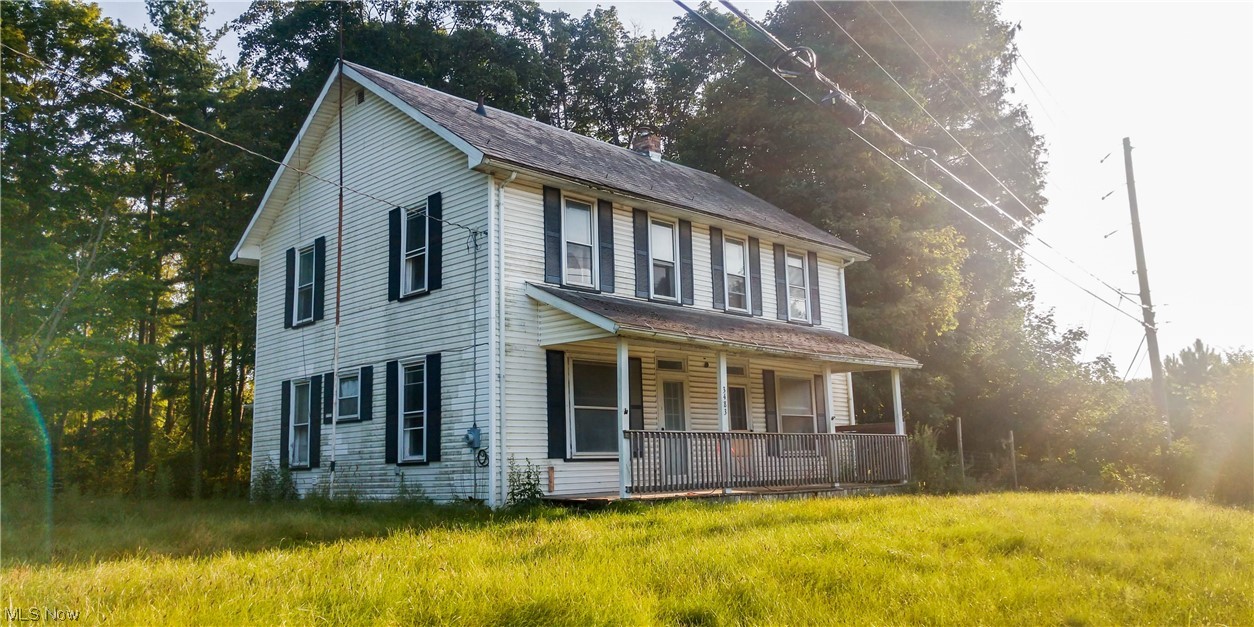 3483 East Garfield Road New Springfield, OH 44443 - Photo 1 of 1 Colonial house with a front lawn and a porch
