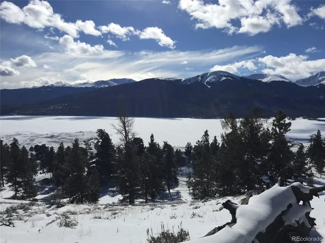 a view of mountain with sunset in background