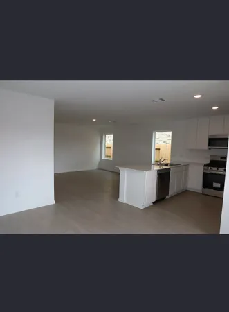 a kitchen with stainless steel appliances a refrigerator and cabinets