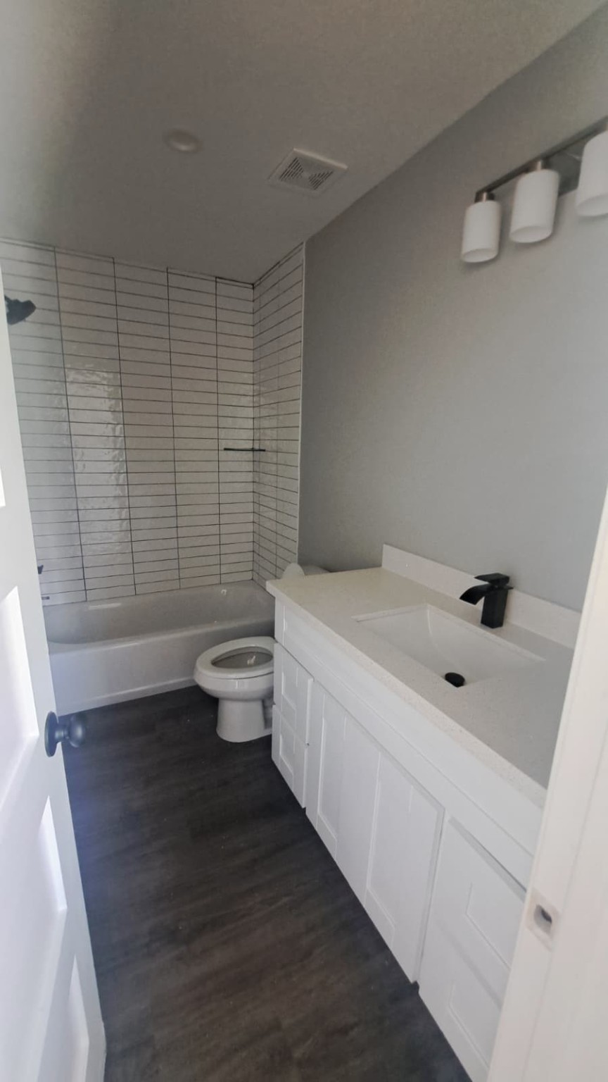 9806 Fillmore Street, Unit C Houston, TX 77029 - Photo 4 of 6 a bathroom with a sink a toilet and shower