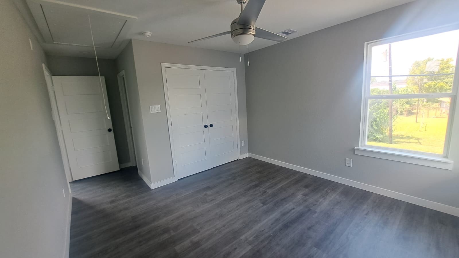 9806 Fillmore Street, Unit C Houston, TX 77029 - Photo 6 of 6 a view of an empty room with wooden floor and a window