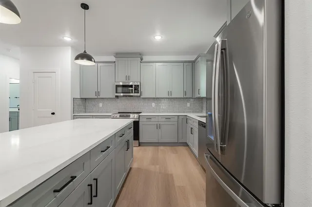 a kitchen with a sink appliances and cabinets