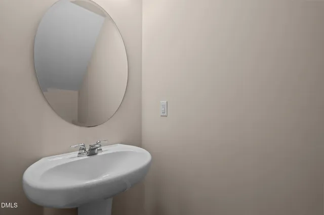 an empty room with a window and a ceiling fan