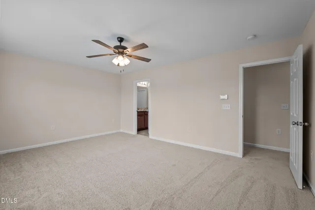 a bathroom with a granite countertop sink a toilet and a shower