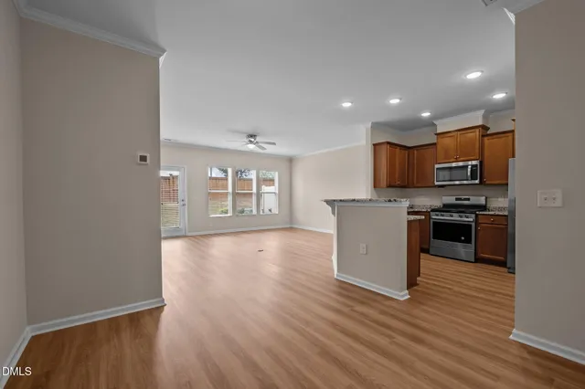 a view of a kitchen with a sink and a refrigerator