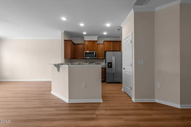 a kitchen with stainless steel appliances granite countertop a stove refrigerator sink and microwave