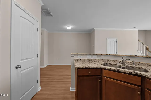 a kitchen with stainless steel appliances white cabinets and a stove top oven