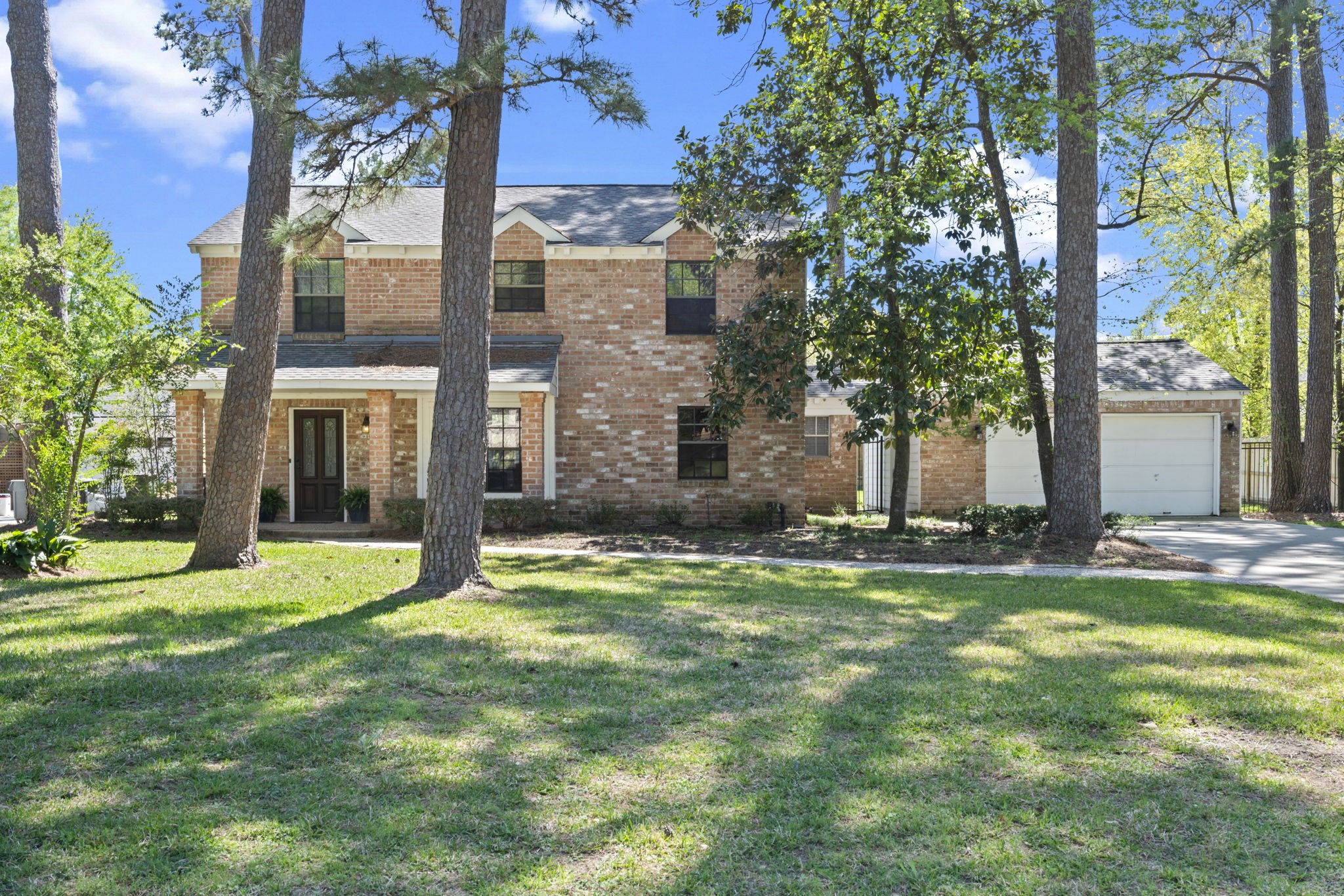 6315 Allentown Drive Spring, TX 77389 - Photo 1 of 46 a view of a big yard in front of a brick house with a large tree