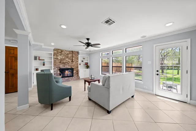 a living room with furniture and floor to ceiling windows