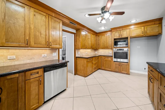 a kitchen with stainless steel appliances granite countertop a sink and cabinets