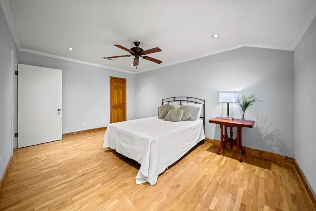 a bedroom with a bed and a chandelier